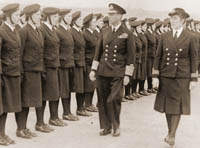 Photo: senior officer inspecting ranks of WRENS